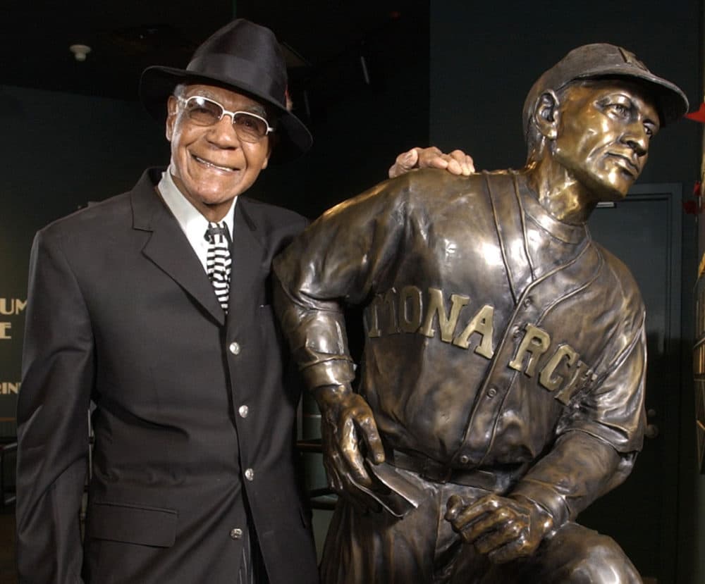 Buck O'Neil stands with a statue of himself in the Negro League Baseball Museum in Kansas City, Mo., in February 2005. O’Neil, a champion of Black ballplayers during a monumental career on and off the field, has joined Gil Hodges, Minnie Minoso and three others in being elected to the baseball Hall of Fame on Dec. 5, 2021. (Charlie Riedel/AP/File)