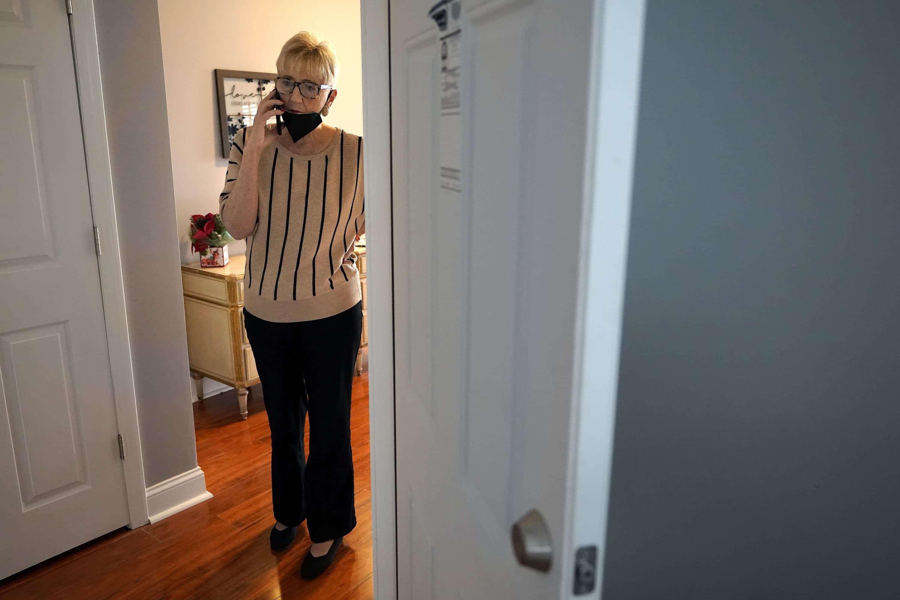 Pastor Judith Hanlon, of Hadwen Park Congregational Church, and co-founder of the LGBT Asylum Task Force, speaks on a phone at a home recently renovated by the ministry task force, in Worcester, Mass. (Steven Senne/AP)