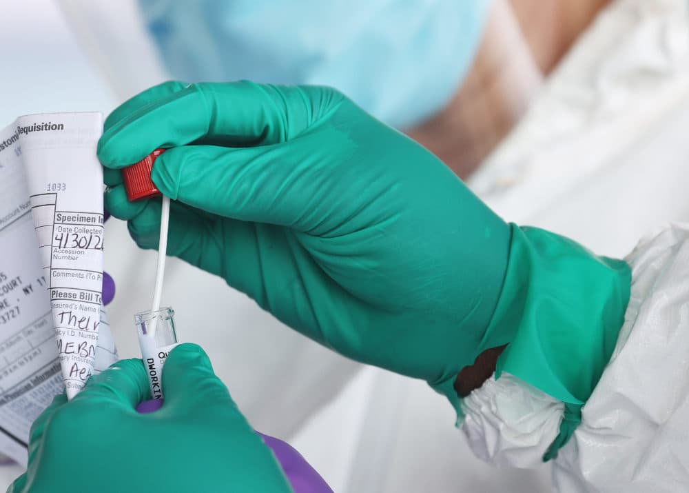 A health care worker seals a coronavirus swab. (Al Bello/Getty Images)