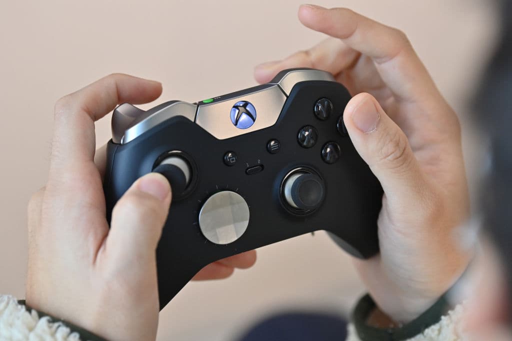 A visitor plays a game using Microsoft's Xbox controller at a flagship store of SK Telecom in Seoul on Nov. 10, 2020. (Jung Yeon-je/AFP/Getty Images)