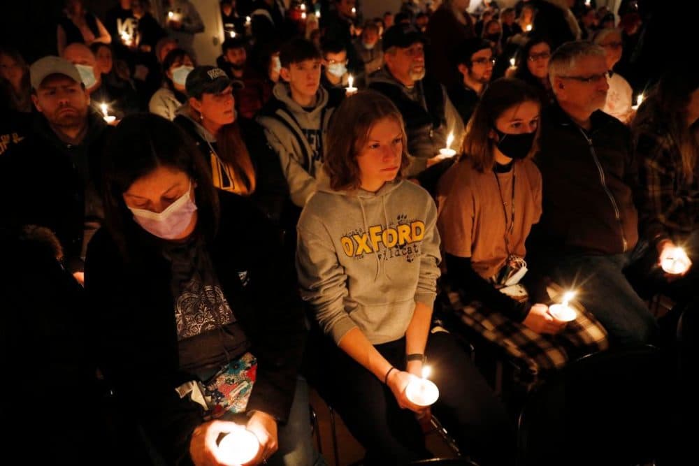 People hold candles during a vigil after a shooting at Oxford High School at Lake Pointe Community Church in Lake Orion, Michigan on November 30, 2021. (Jeff Kowalsky/AFP via Getty Images)
