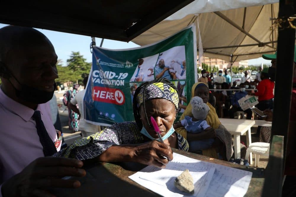 A worker registers for compulsory vaccination after being barred into office for not complying with the order at the State Secretariat in Abuja, Nigeria, on December 1, 2021. (Kola Sulaimon/AFP  via Getty Images)