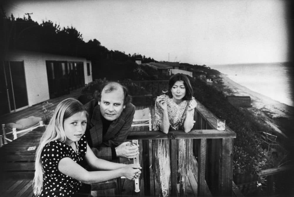 On a patio deck overlooking the ocean, Quintana Roo Dunne (L) leans on a railing with her parents, American authors and scriptwriters John Gregory Dunne and Joan Didion, Malibu, California, 1976. (John Bryson/Getty Images)