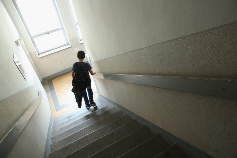 A 6th grade pupil walks down a stairwell at his middle school. (Sean Gallup/Getty Images)