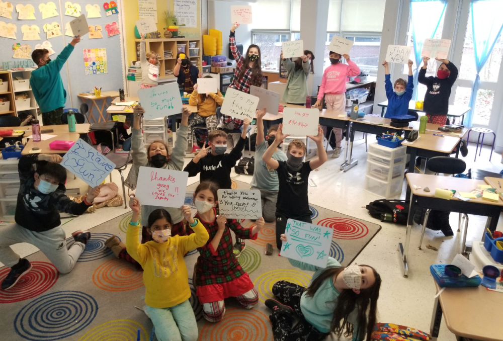 Students hold up signs thanking Gregory Tang for making math fun. (Courtesy of Gregory Tang)