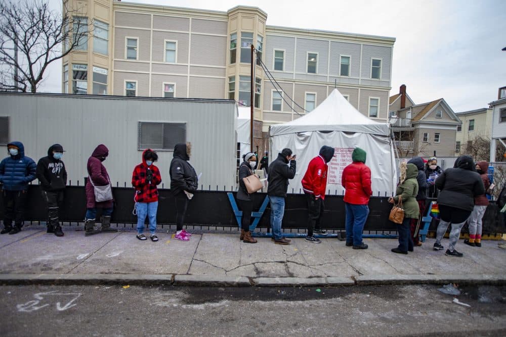 A line of people wait at the Bowdoin Street Health Center for COVID-19 tests on Monday. (Jesse Costa/WBUR)