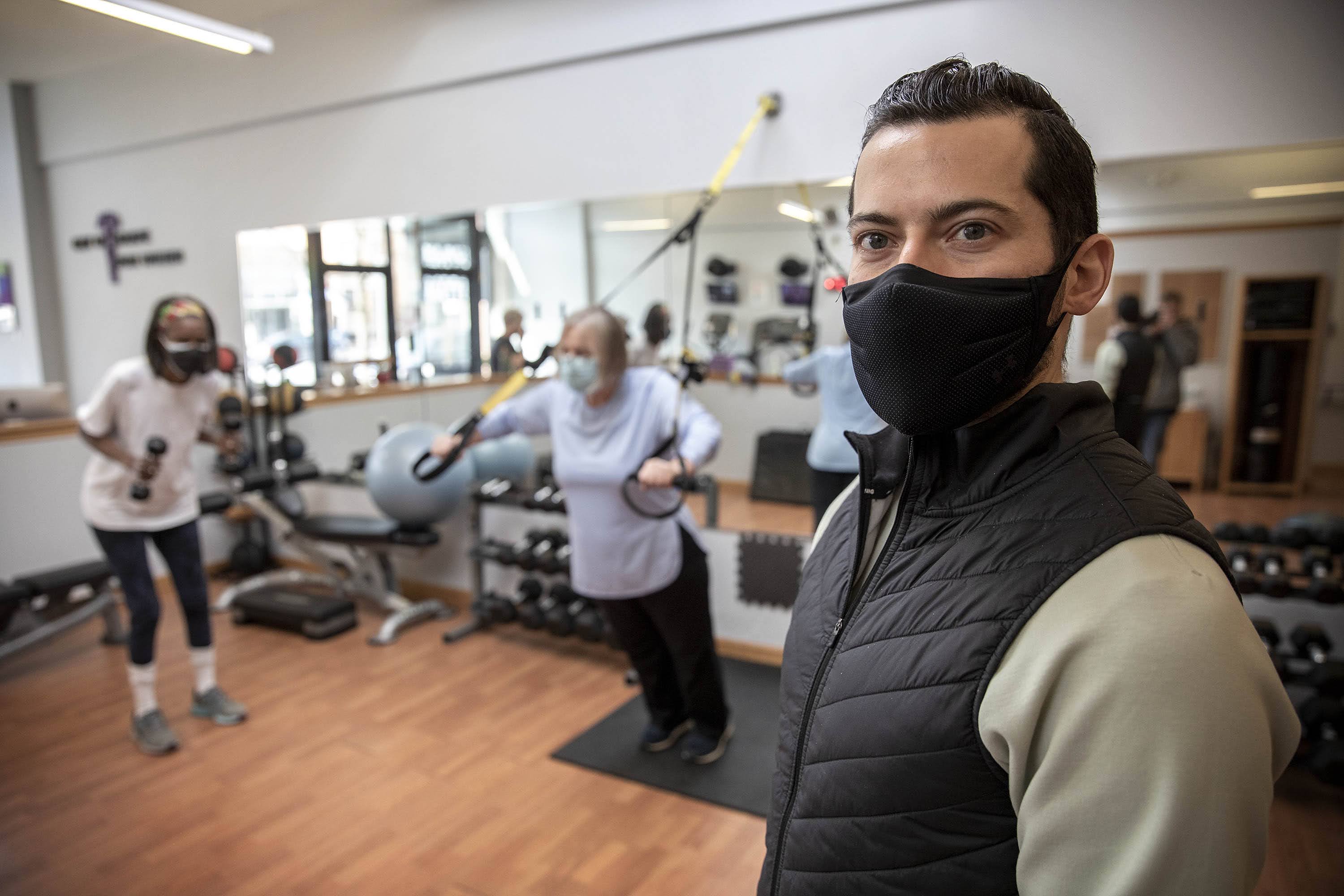 Personal trainer John Pecchia at Get In Shape For Women gym in Cambridge. (Robin Lubbock/WBUR)