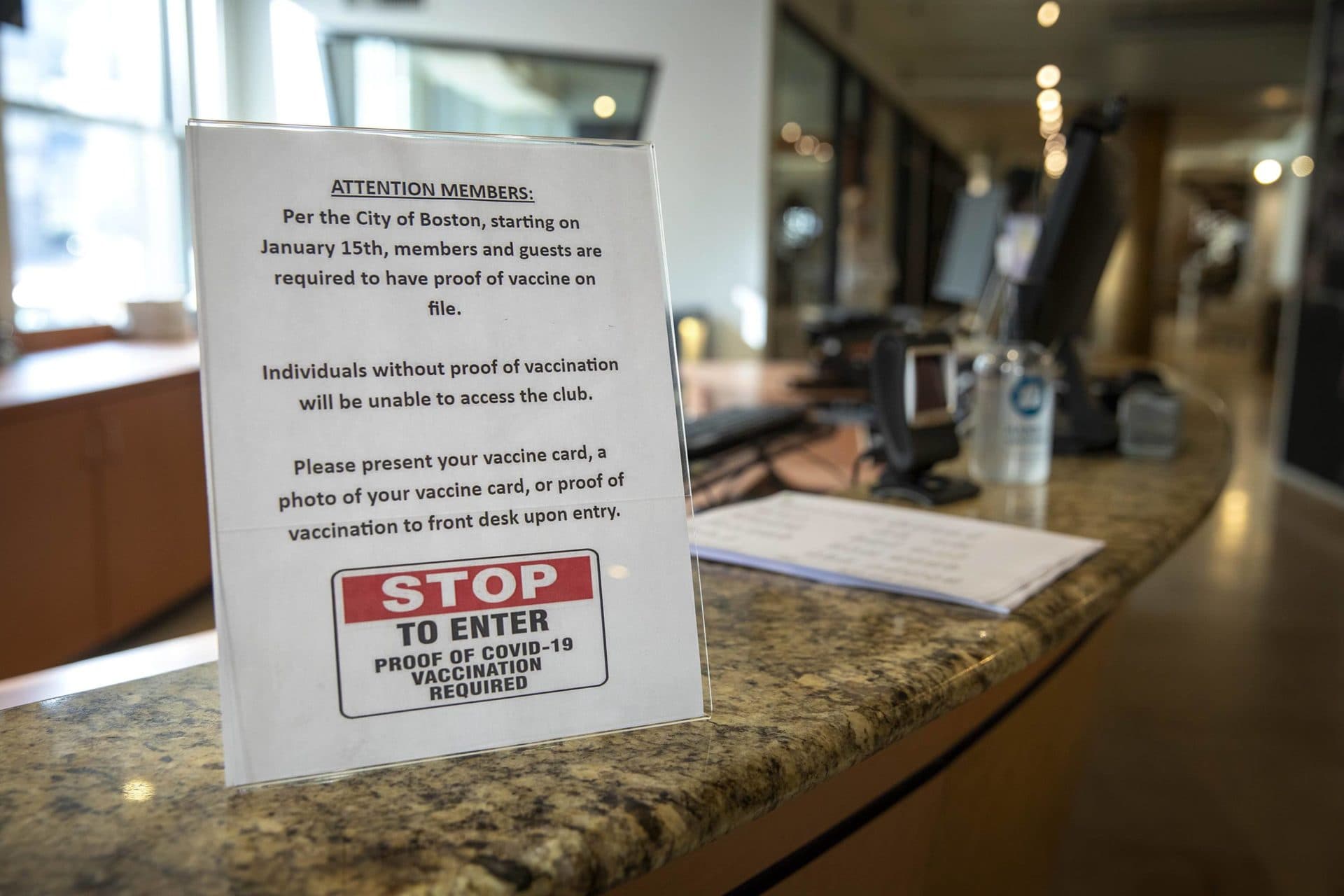 Healthworks on Stuart Street displays a sign informing members they must have proof of COVID-19 vaccination to enter the club, starting on January 15, 2022. (Robin Lubbock/WBUR)