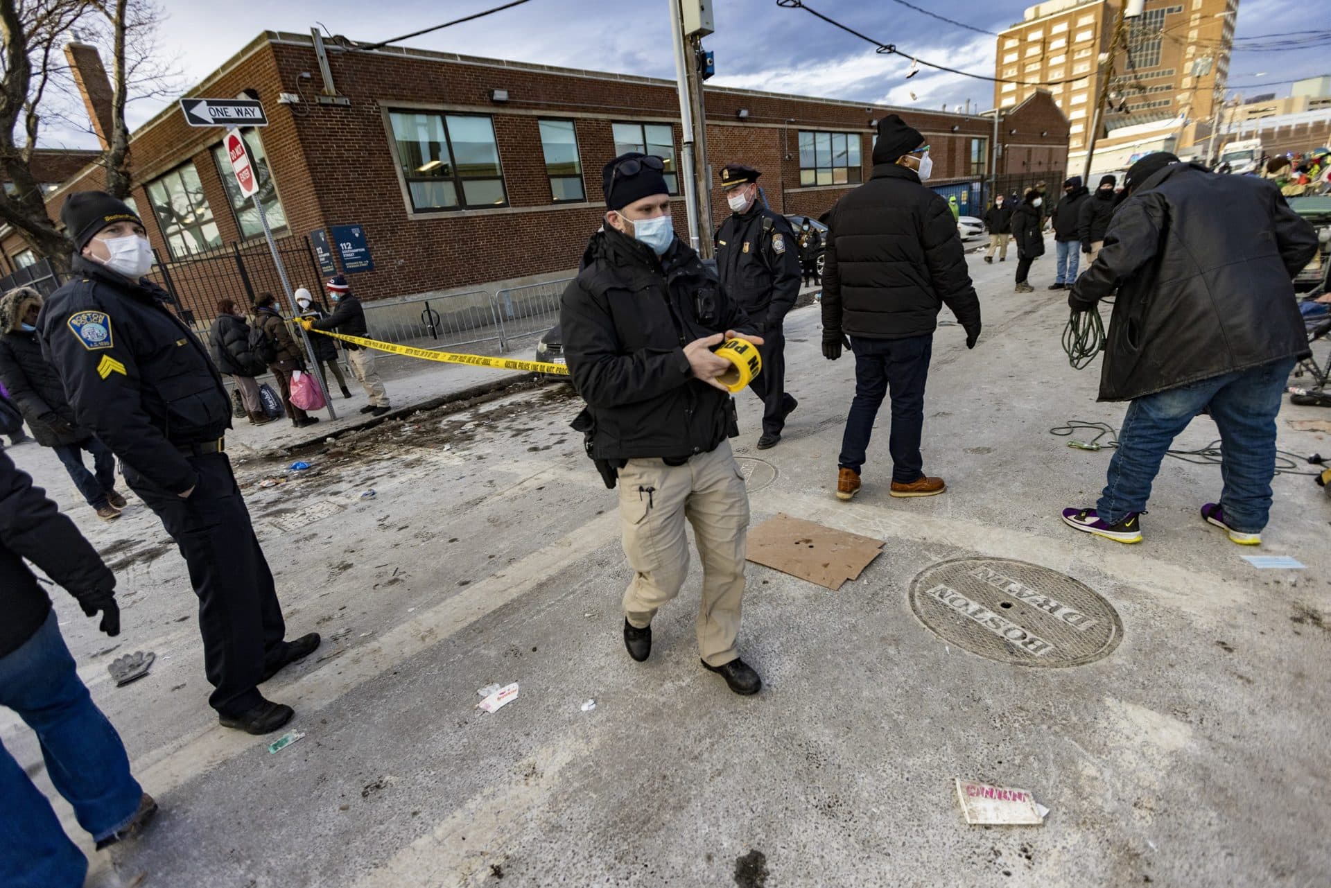 Boston Police block off Atkinson Street with caution tape after they removed the tent inhabitants to remove the dwellings. (Jesse Costa/WBUR)
