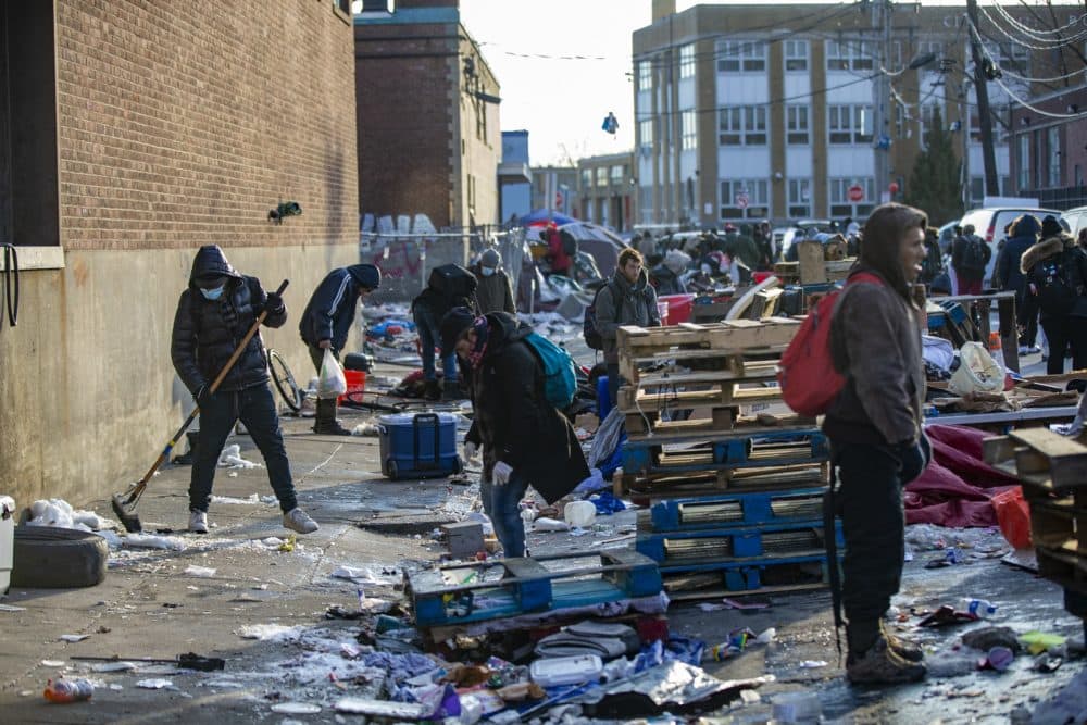 Workers begin to clean up Atkinson Street after tents and large pieces of debris were removed. (Jesse Costa/WBUR)