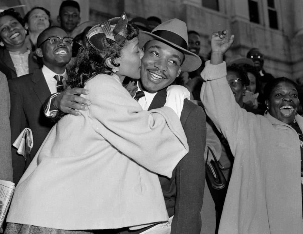 The Rev. Martin Luther King Jr. is welcomed with a kiss by his wife, Coretta, after leaving court in Montgomery, Ala., in 1956. (Gene Herrick/AP)