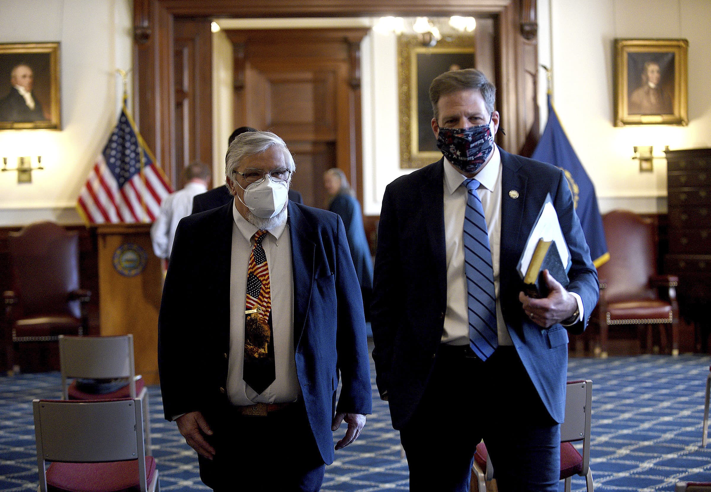 Gov. Chris Sununu walks with House Speaker Sherm Packard, R-Londonderry, at his inauguration ceremony in the Executive Council Chamber at the State House in Concord, N.H., on Thursday, Jan. 7, 2021. The new year brings new laws for New Hampshire, including an abortion ban that was passed as part of the state budget. (David Lane/The Union Leader via AP)