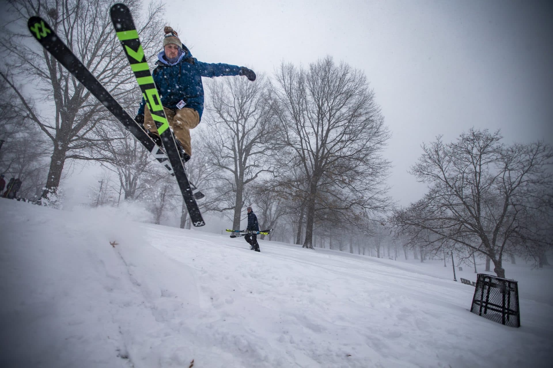 Kevin Moore attempts a 360 degree spin as he ski jumps down the hill of the Soldier’s and Sailor’s Monument in the Boston Common. (Jesse Costa/WBUR)
