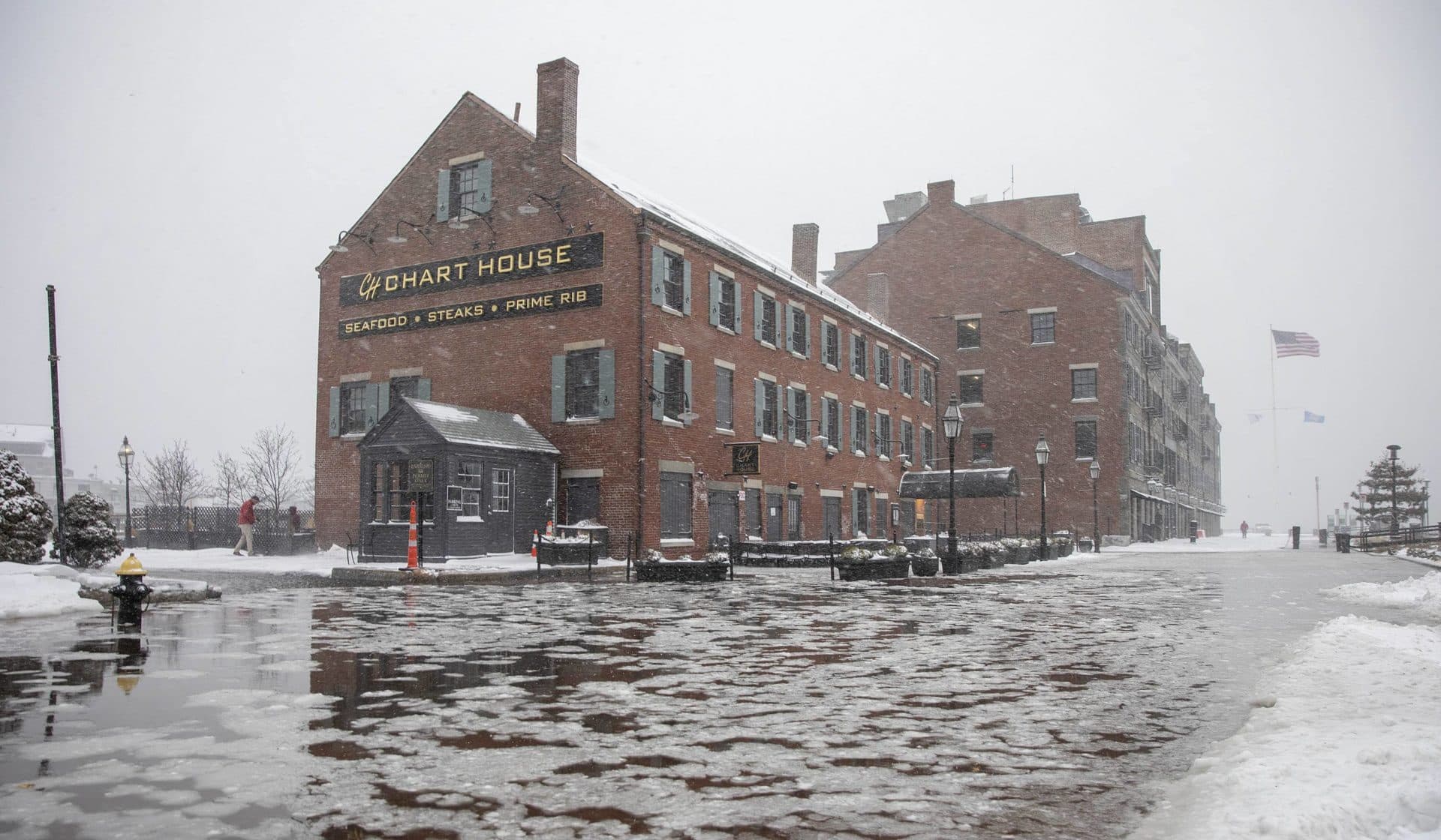 High tide early on Saturday morning during the snow storm creates flooding on Long Wharf by the Chart House. (Robin Lubbock/WBUR)