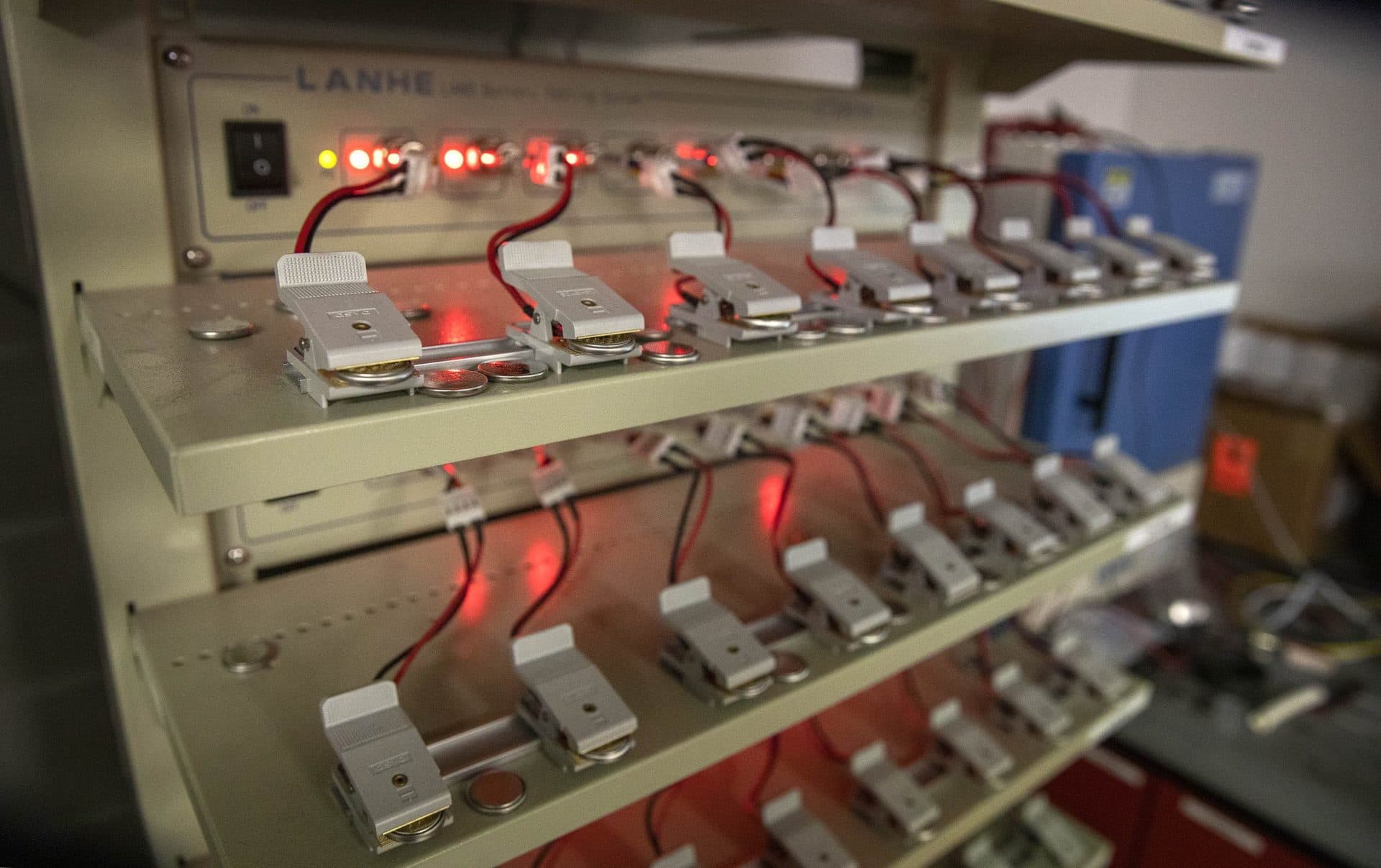 Coin batteries undergo testing at Professor Yan Wang's laboratory at Worcester Polytechnic Institute. (Robin Lubbock/WBUR)