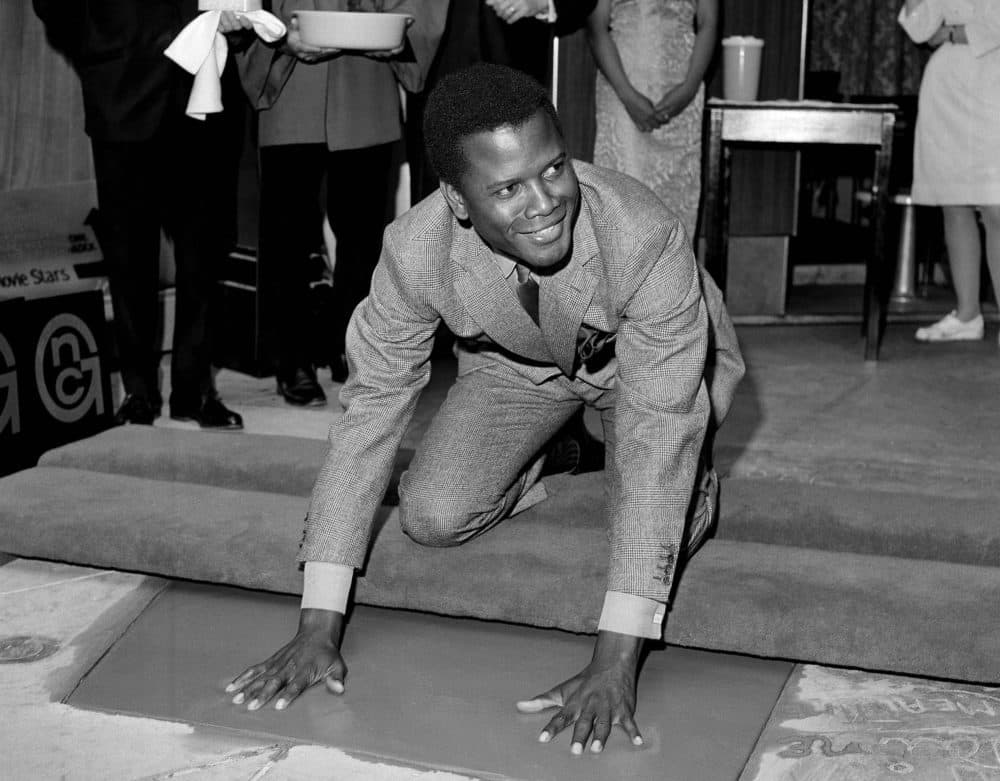 Sidney Poitier, star of &quot;To Sir With Love,&quot; places his hands in wet cement at Grauman's Chinese Theater in Los Angeles on June 23, 1967. (AP)