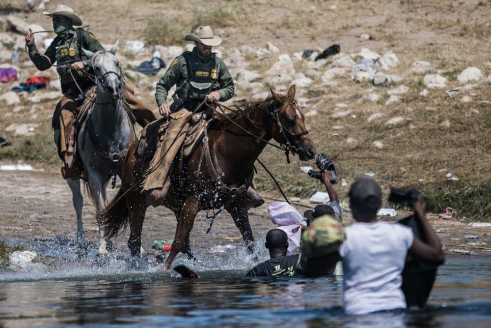 Mounted U.S. Border Patrol agents attempt to contain migrants as they cross the Rio Grande from Ciudad Acuña, Mexico, into Del Rio, Texas, Sept. 19, 2021. (Felix Marquez/AP)