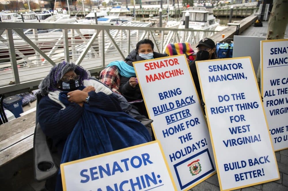 A group of West Virginians bundled against the cold wait by the entrance to the yacht club where Senator Joe Manchin (R-WV) lives. (Joy Asico/AP Images for CPD Action)