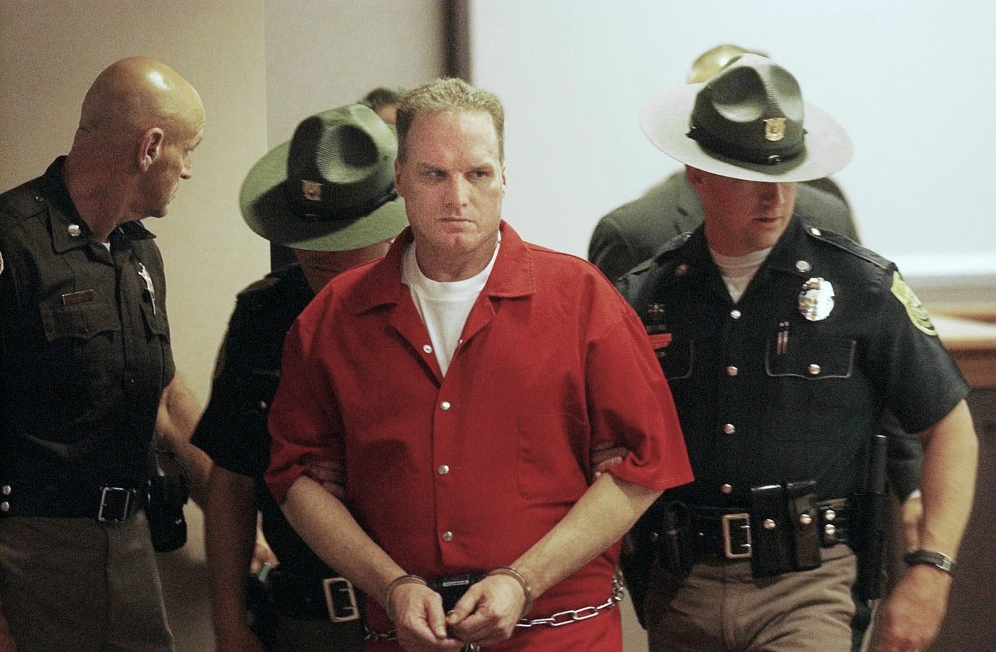 Gary Lee Sampson, center, is escorted into Hillsborough County Superior Court, June, 1 2004, in Nashua, N.H. A federal appeals court is considering vacating the murder convictions of Sampson, convicted of killing two Massachusetts men in carjackings in 2001, because he was still appealing his execution when he died in prison last month. (Jim Cole/AP File)