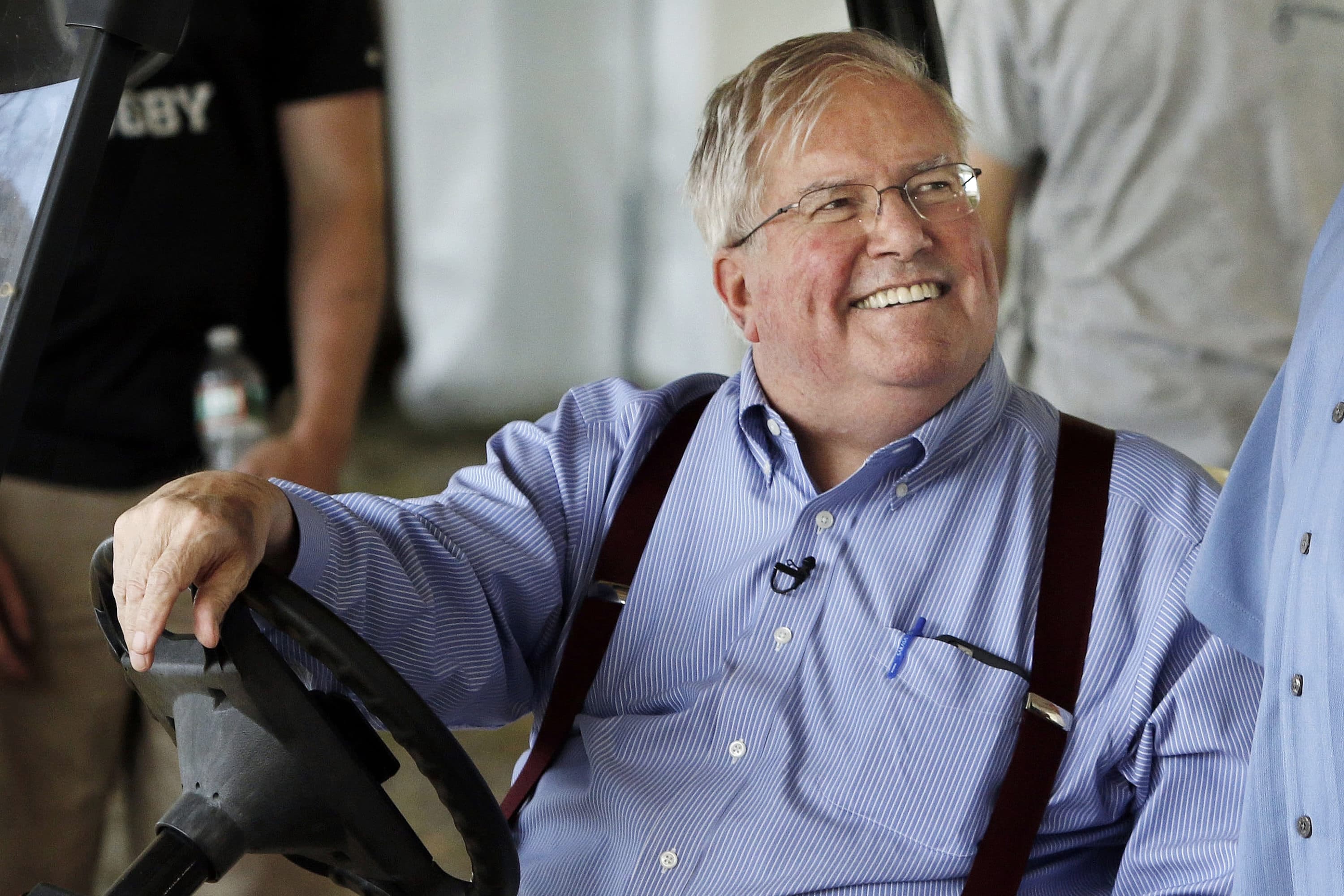 David Mugar, founder and executive director of the Boston Pops Fireworks Spectacular, smiles while sitting in a golf cart on June 29, 2016, along the Charles River Esplanade in Boston. (Bill Sikes/AP)