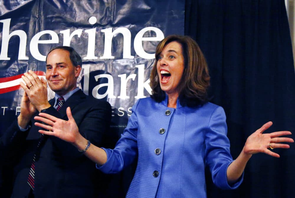 Democrat Katherine Clark reacts to supporters as her husband, Rod, applauds at her election night party in Stoneham, Mass., Tuesday, Dec. 10, 2013, where she claimed victory in a special election for the vacated seat in Massachusetts' 5th Congressional District. (Elise Amendola/AP)