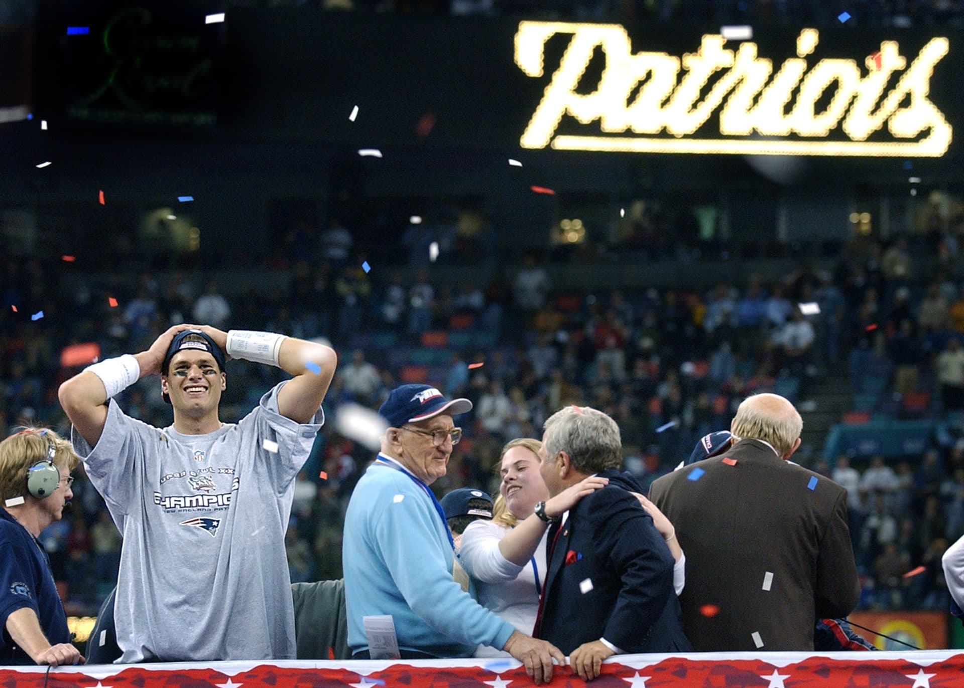 New England Patriots quarterback and Super Bowl MVP Tom Brady reacts on the podium following New England's upset victory over the St. Louis Rams in Super Bowl XXXVI at the Louisiana Superdome in New Orleans on Feb. 3, 2002. (Jim Davis/The Boston Globe via Getty Images)