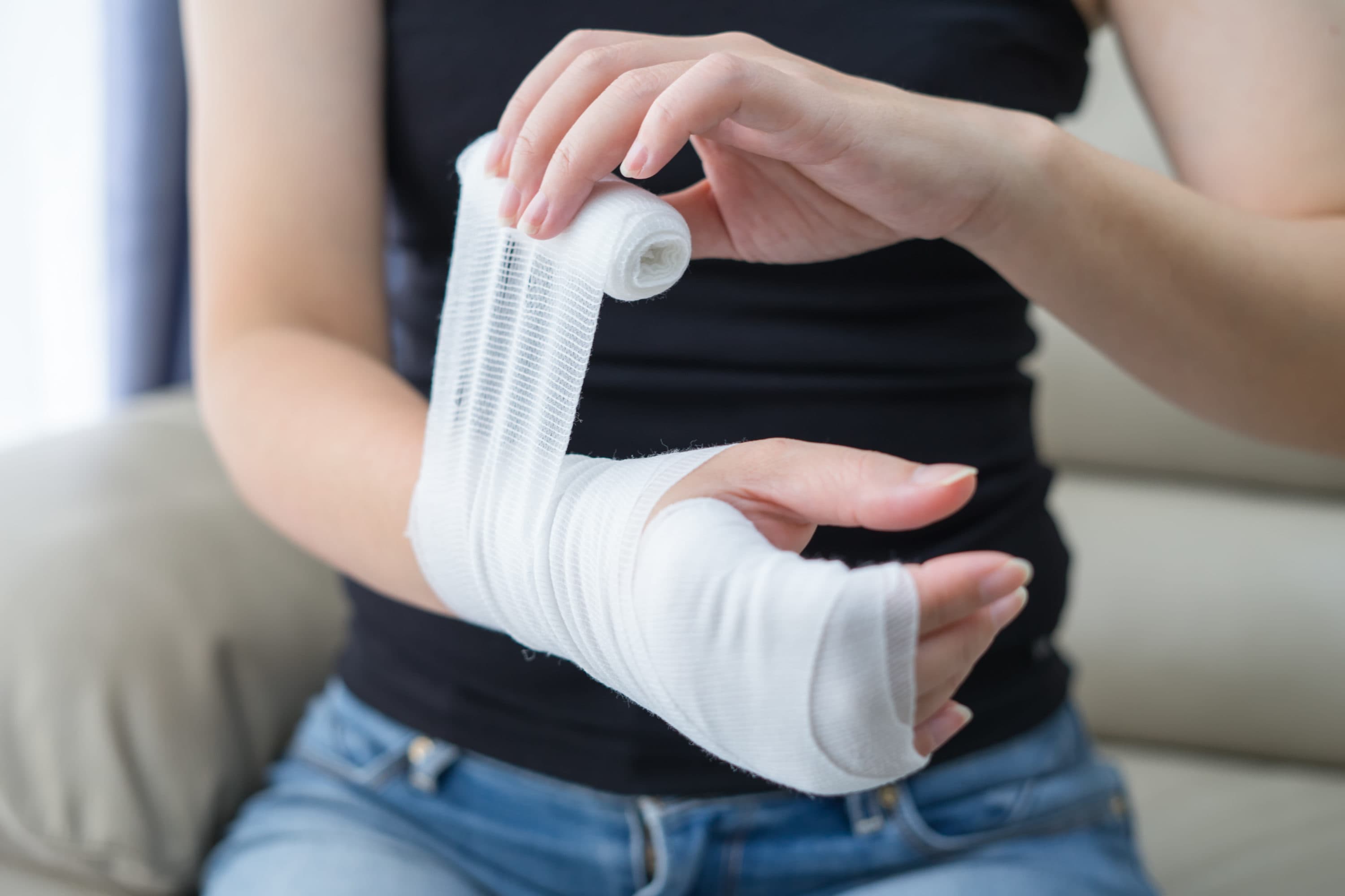 A woman bandages her hand. (Getty Images)