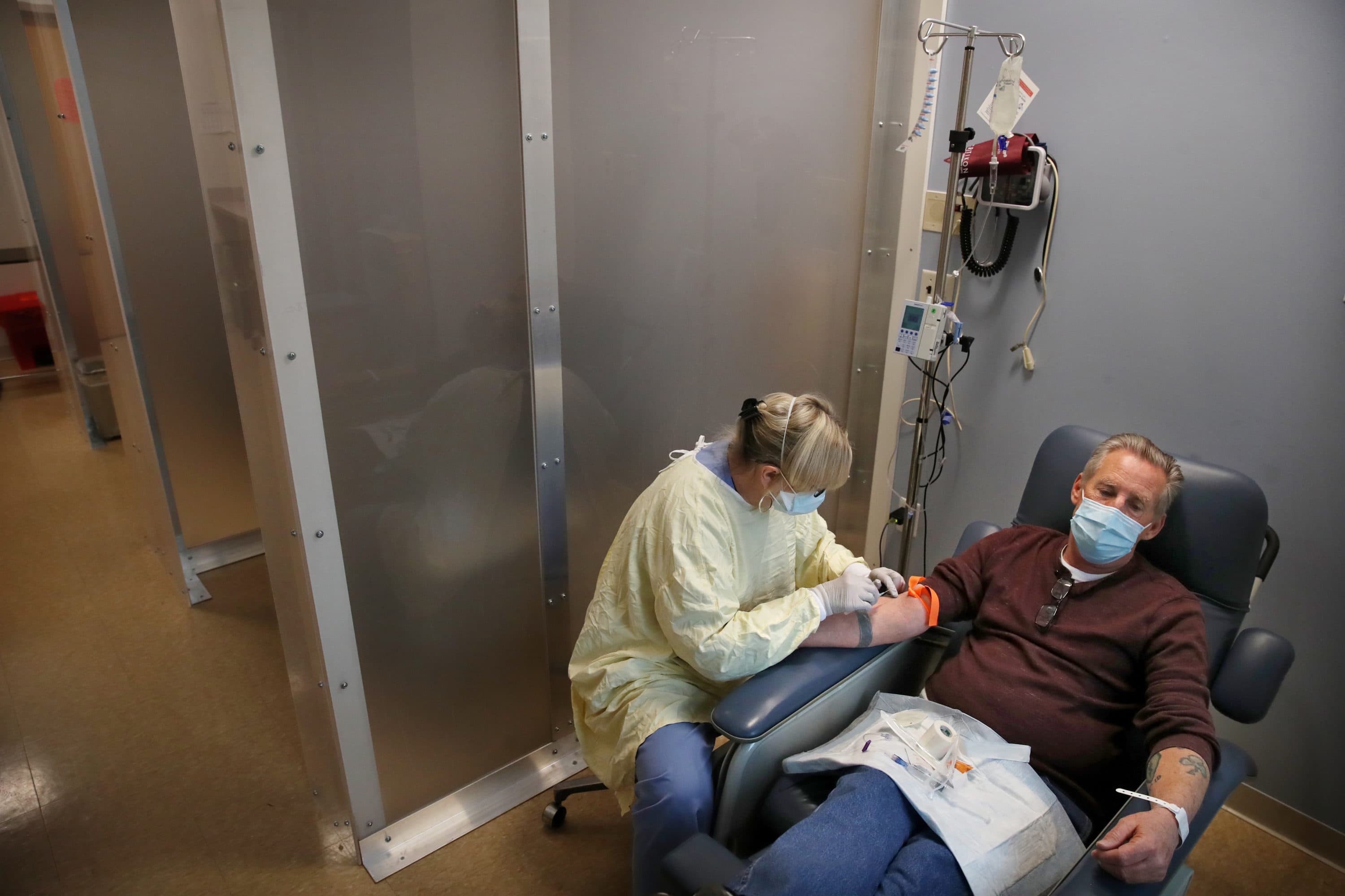 A patient at Tufts Medical Center in Boston receives a monoclonal antibody treatment. (Craig F. Walker/The Boston Globe via Getty Images)
