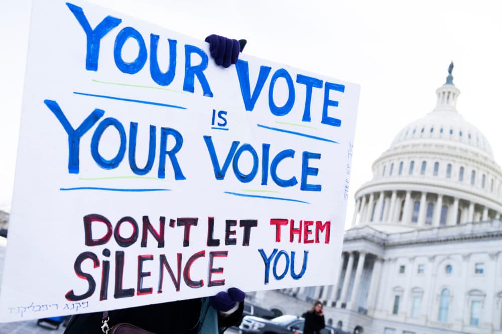 A demonstrator holds a sign at rally with Rep. Jamaal Bowman, D-N.Y., outside the U.S. Capitol to urge the Senate to pass voting rights legislation on Wednesday, January 19, 2022. (Tom Williams/CQ-Roll Call, Inc via Getty Images)