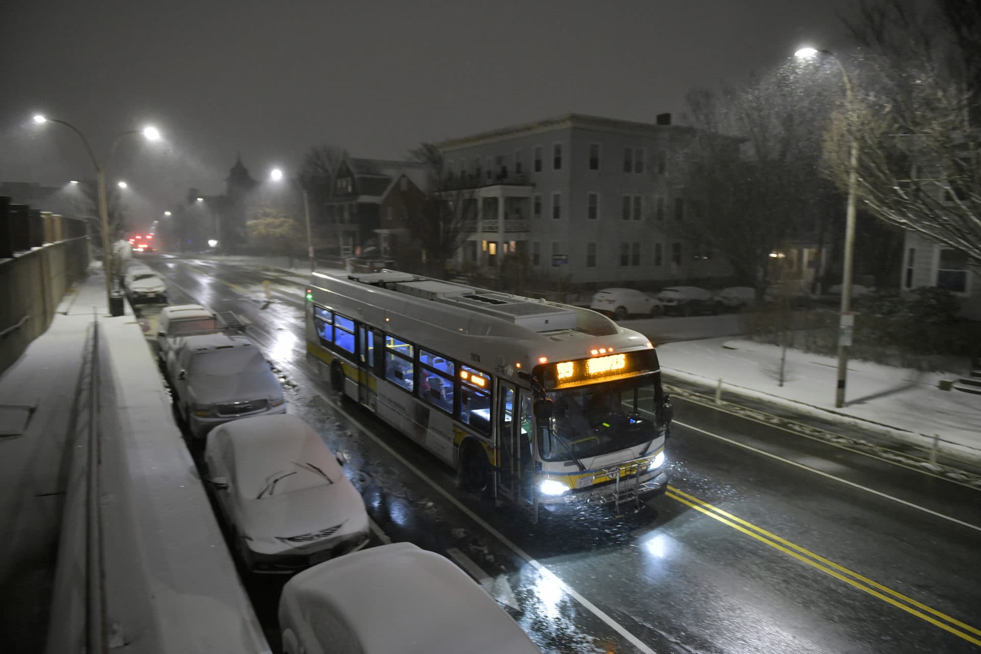An MBTA bus makes its rounds at the beginning of a major snowstorm arrives Saturday. (Josh Reynolds/AP)