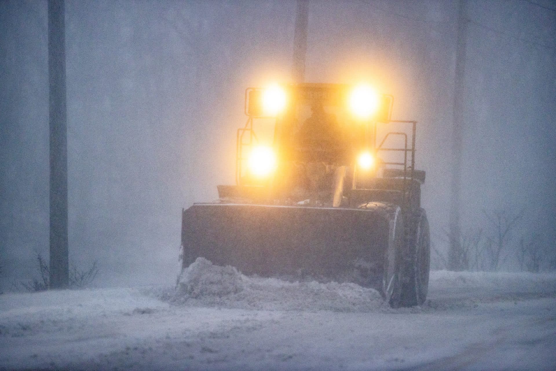 A plow moves snow in whiteout conditions on East Squantum Street in Quincy during the snowstorm Saturday. (Stan Grossfeld/The Boston Globe via Getty Images)
