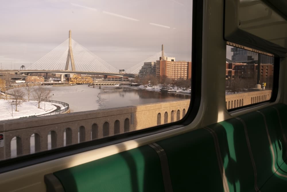 The Zakim Bridge is visible from the window as an MBTA Green Line train approaches Science Park station, which has been closed to riders since May 2020 and will reopen when the first branch of the Green Line Extension launches in March. (Chris Lisinski/SHNS)