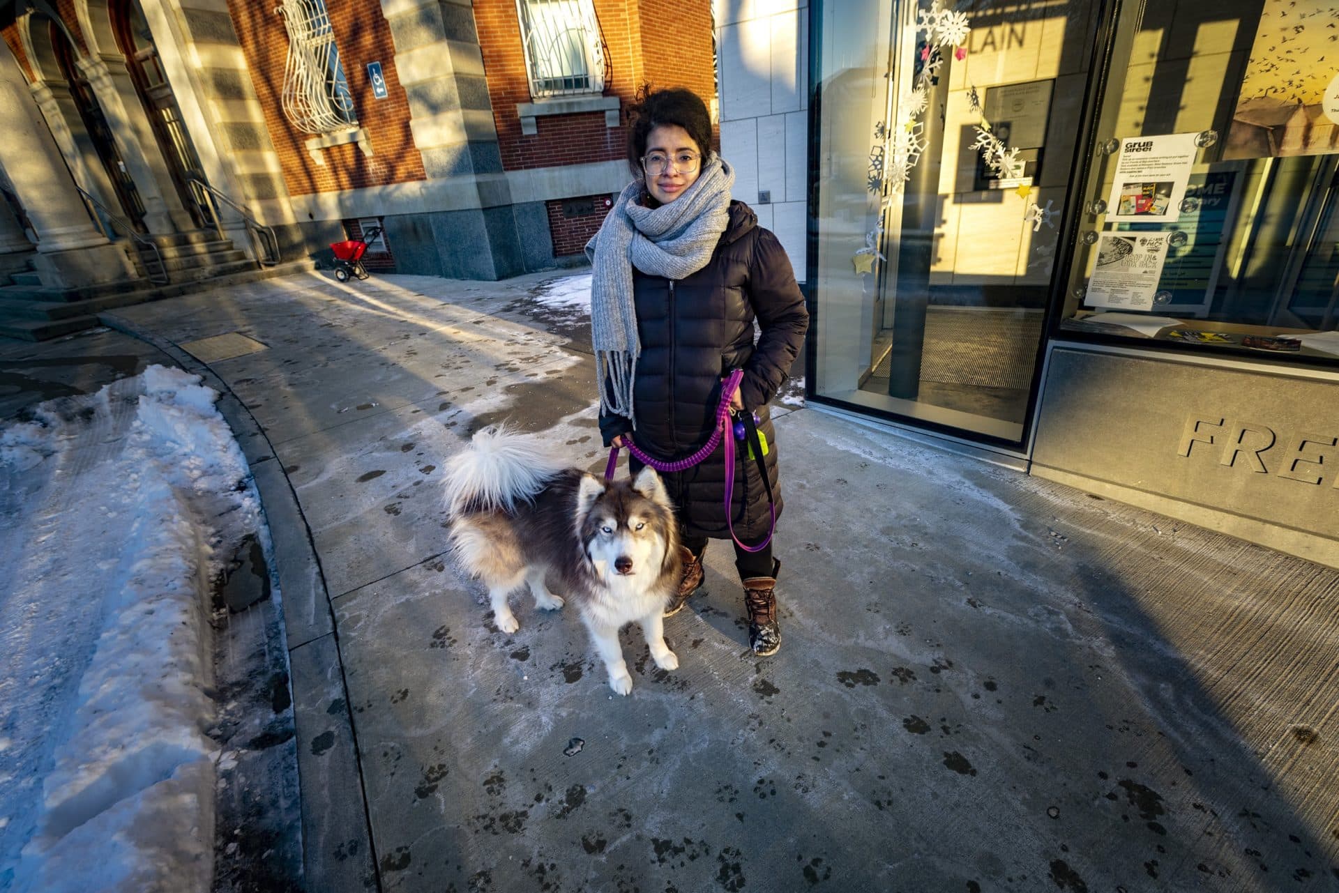 Tatiana Saenz with her dog outside of the Jamaica Plain branch of the Boston Public Library. (Jesse Coista/WBUR)