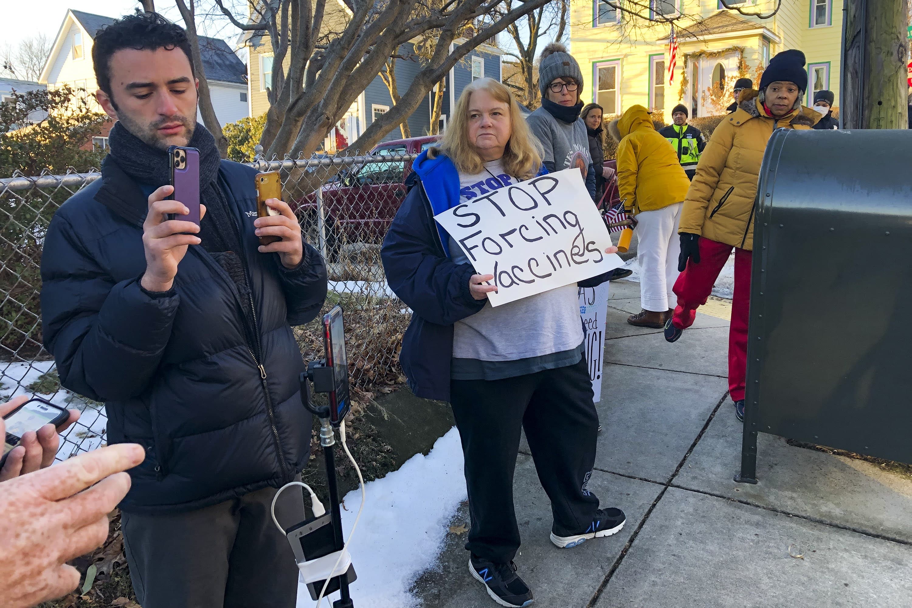 Protesters who oppose vaccine mandates show up every morning outside the home of Boston Mayor Michelle Wu in Roslindale. (Anthony Brooks/WBUR)