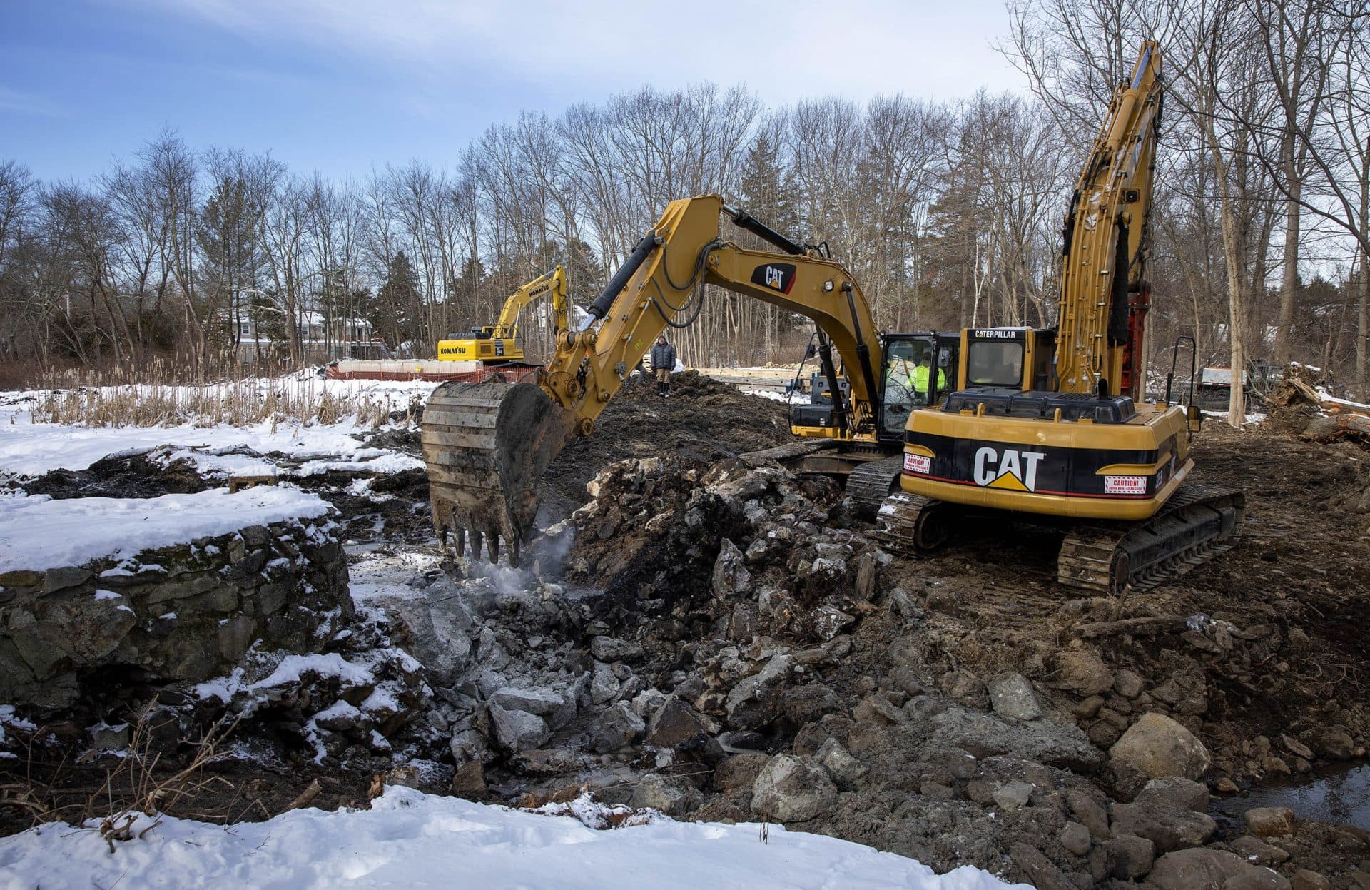 A differ removes rubble that once held back the water on Traphole Brook. (Robin Lubbock/WBUR)