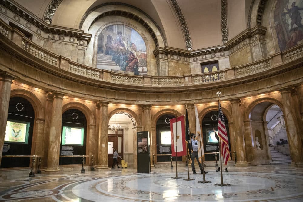 Memorial Hall, or The Hall of Flags, at the Massachusetts State House. The mural, &quot;Return of the Colors,&quot; is seen above. (Robin Lubbock/WBUR)