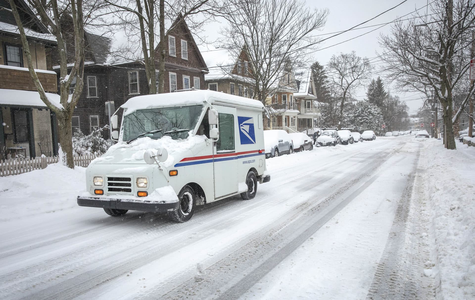 Undeterred by the snow, a Post Office vehicle makes its deliveries in Cambridge. (Robin Lubbock/WBUR)