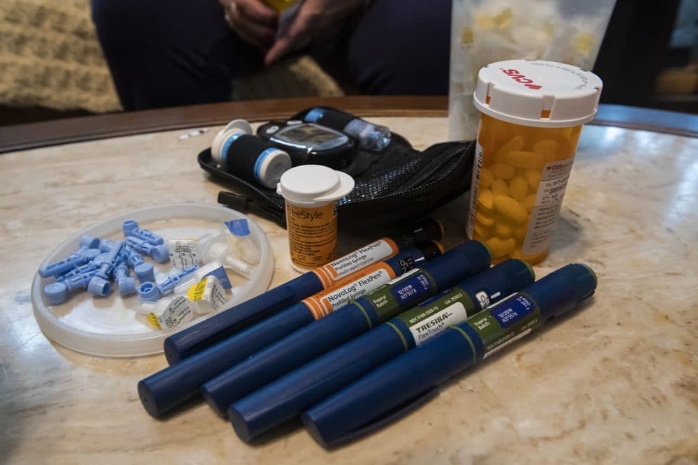 Joanne Rhoton's prescriptions laid out on a table in her Everett home. Rhoton spoke with WBUR in 2019 as part of a story about the high costs of prescription drugs. (Jesse Costa/WBUR)