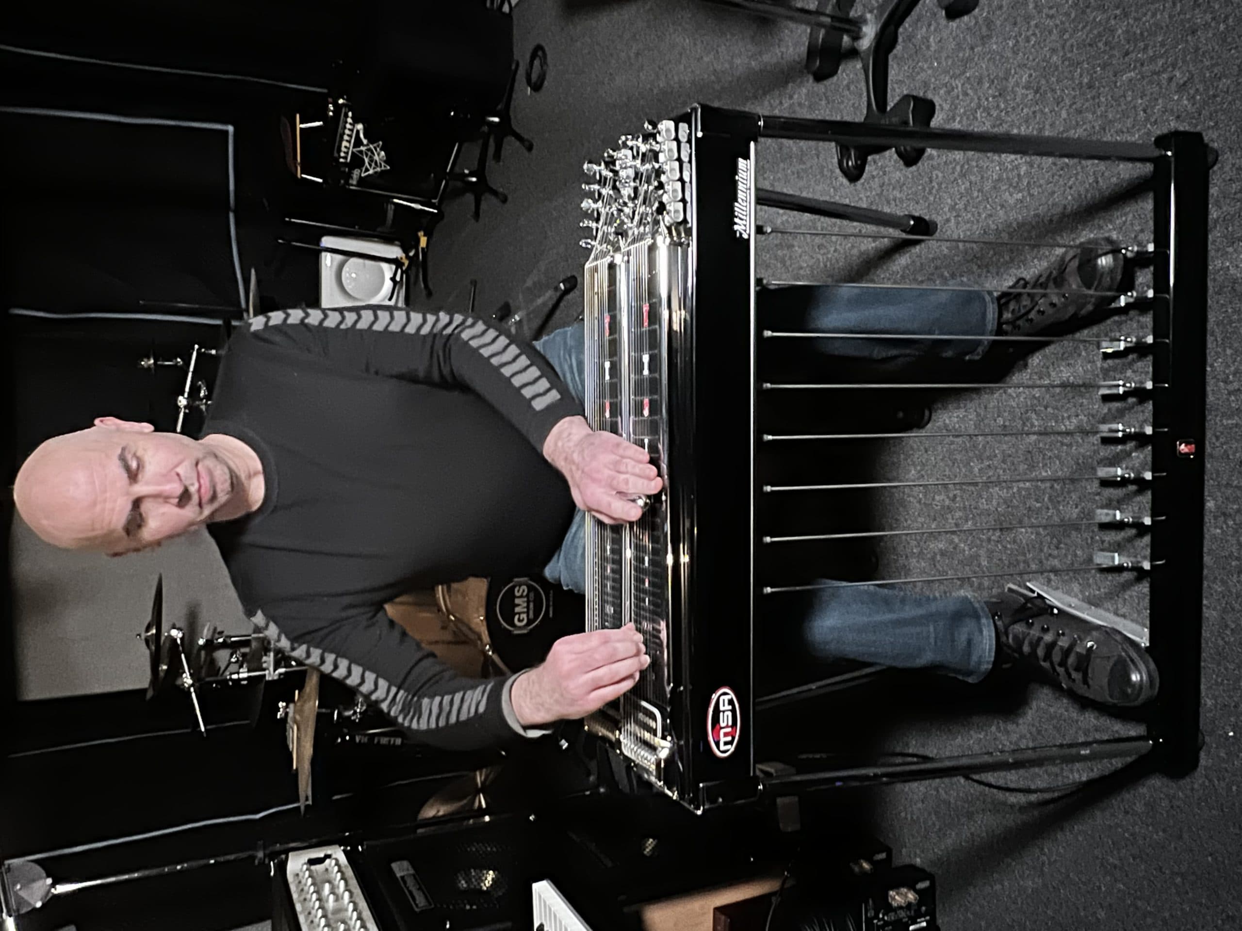 With both hands, both feet, and both knees all moving together to bring this instrument to life, composer Eric Shimelonis (pictured here) compares playing the pedal steel to knitting a sweater while flying a helicopter – at the exact same time! (courtesy of Rebecca Sheir)