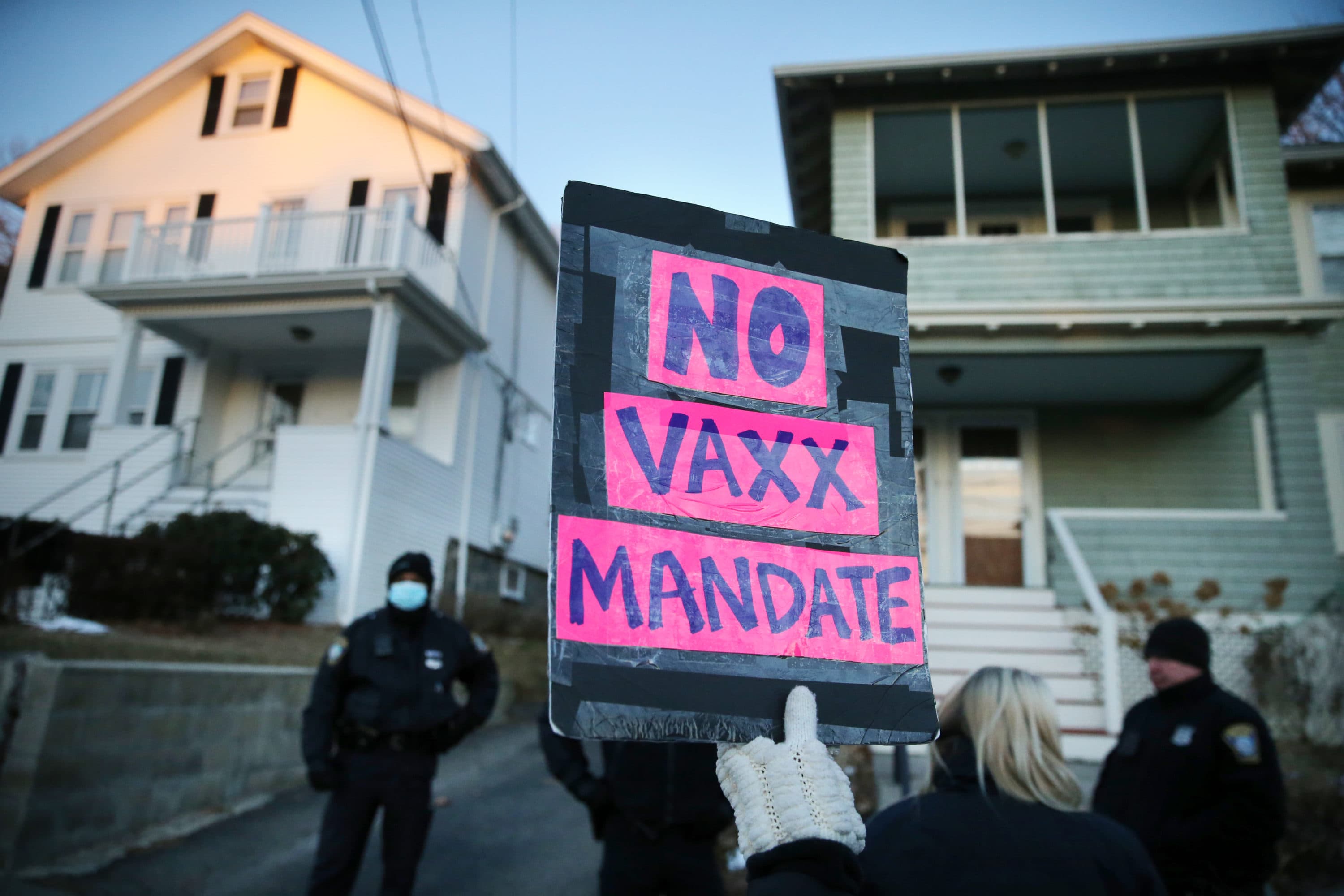 Demonstrators protest outside the home of Boston Mayor Michelle Wu in Roslindale on Jan. 25. The group was protesting the vaccine mandate in Boston. (Craig F. Walker/The Boston Globe via Getty Images)