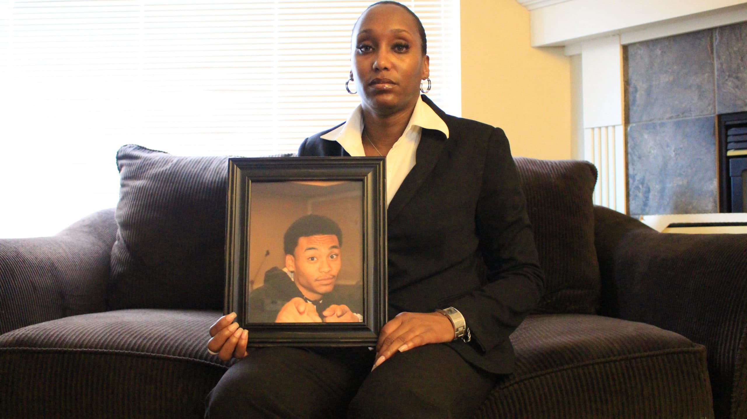 Shalisa Hayes holds a photo of her son, Billy Ray Shirley. (Courtesy Shalisa Hayes)