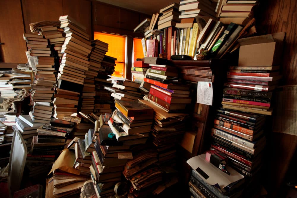 Books sit stacked in a bedroom at a hoarder's home on April 8, 2011 in San Diego, California. (Sandy Huffaker/Getty Images for YOU Magazine)