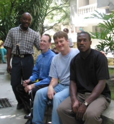 From left, Dr. Fernet Leandre, Dr. Paul Farmer, Paul English and Ti Jean, in Cange, Haiti circa October 2003. (Courtesy Paul English)