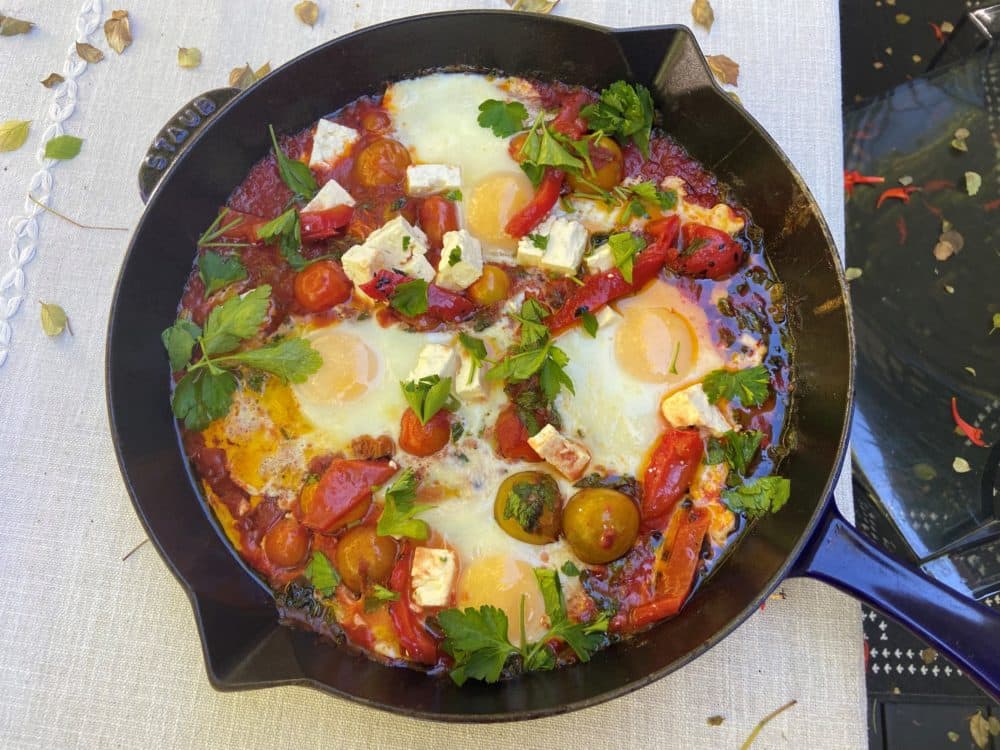Shakshuka, an Israeli favorite that combines a spicy tomato sauce baked with eggs and a scattering of cheese. (Kathy Gunst)