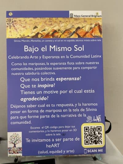 &quot;Bajo el Mismo Sol Under the Same Sun&quot; Poster in Spanish to accompany community-building art installation at MGH — a celebration of internal topographies, journeys and la comunidad through the mixed media work of Argentinian American artist Silvina Mizrahi. (Photo by Megan Carleton)