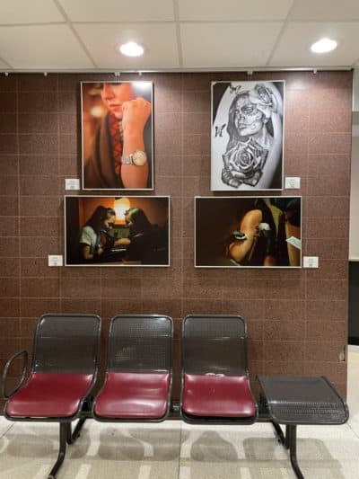 A portion of the &quot;Drawn Skin&quot; exhibit at MGH, a collection of photos exploring the universality of body art and reflecting shared humanity and connections. (Photo by Megan Carleton)