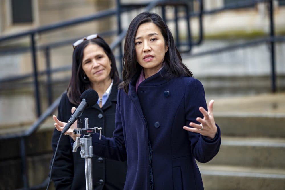 Mayor Michelle Wu speaks to the news media during a press conference at Brighton High School on March 22, 2022, where Boston Public Schools Superintendent Brenda Cassellius (left) announced she would resign at the end of the 2021-2022 school year. (Jesse Costa/WBUR)