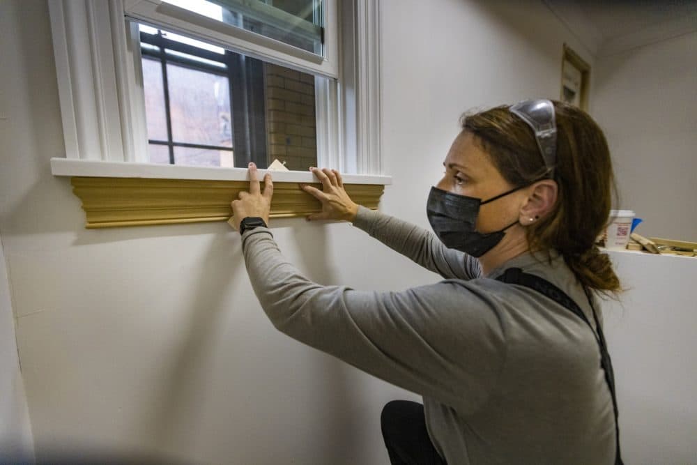 Danielle Chagnon fits a piece of molding beneath a window sill during class at the North Bennet Street School in Boston's North End. Chagnon wants to make a career change from being a math teacher to a contractor. (Jesse Costa/WBUR)