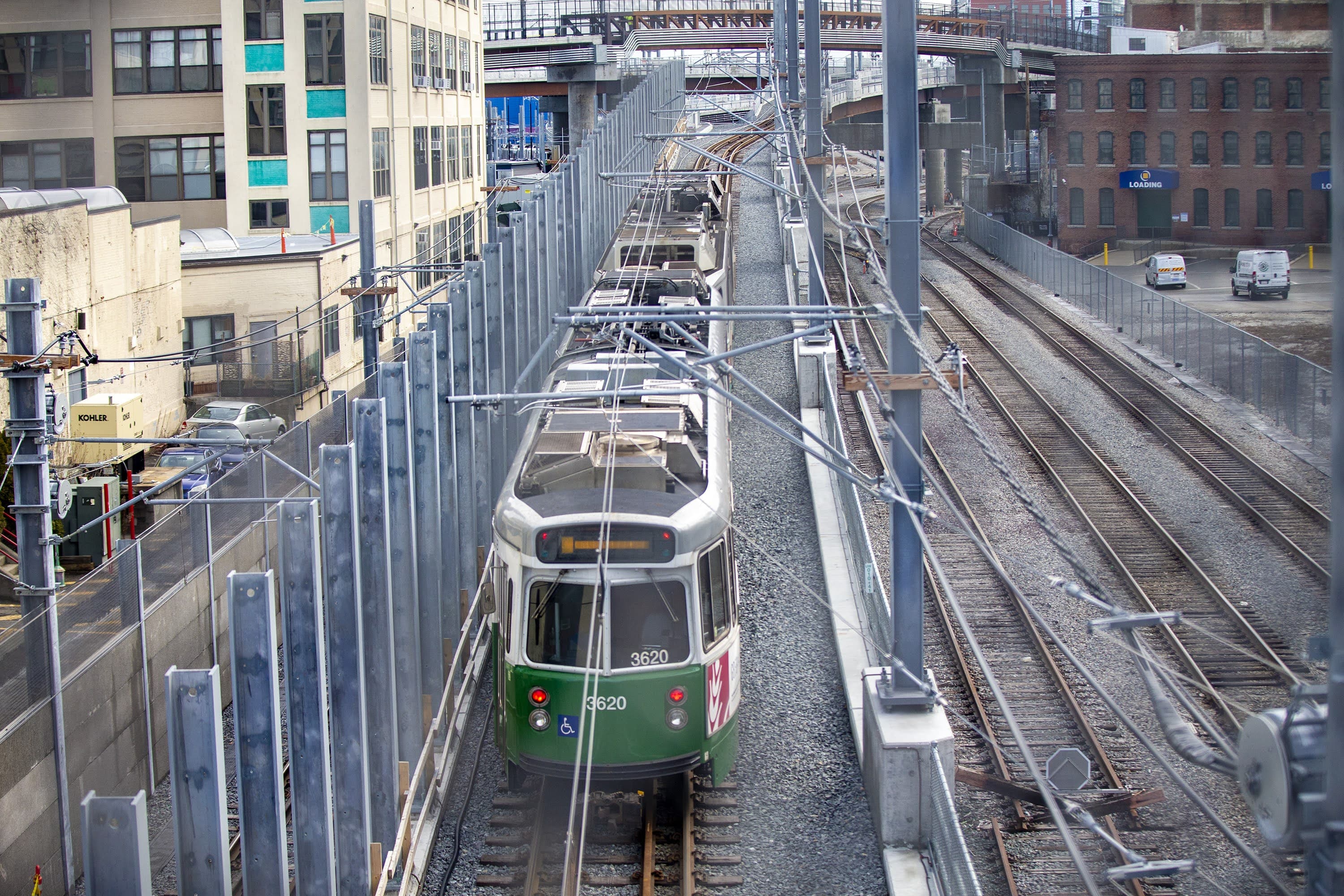 An MBTA train rides on the tracks along McGrath Highway in Somerville. (Jesse Costa/WBUR)