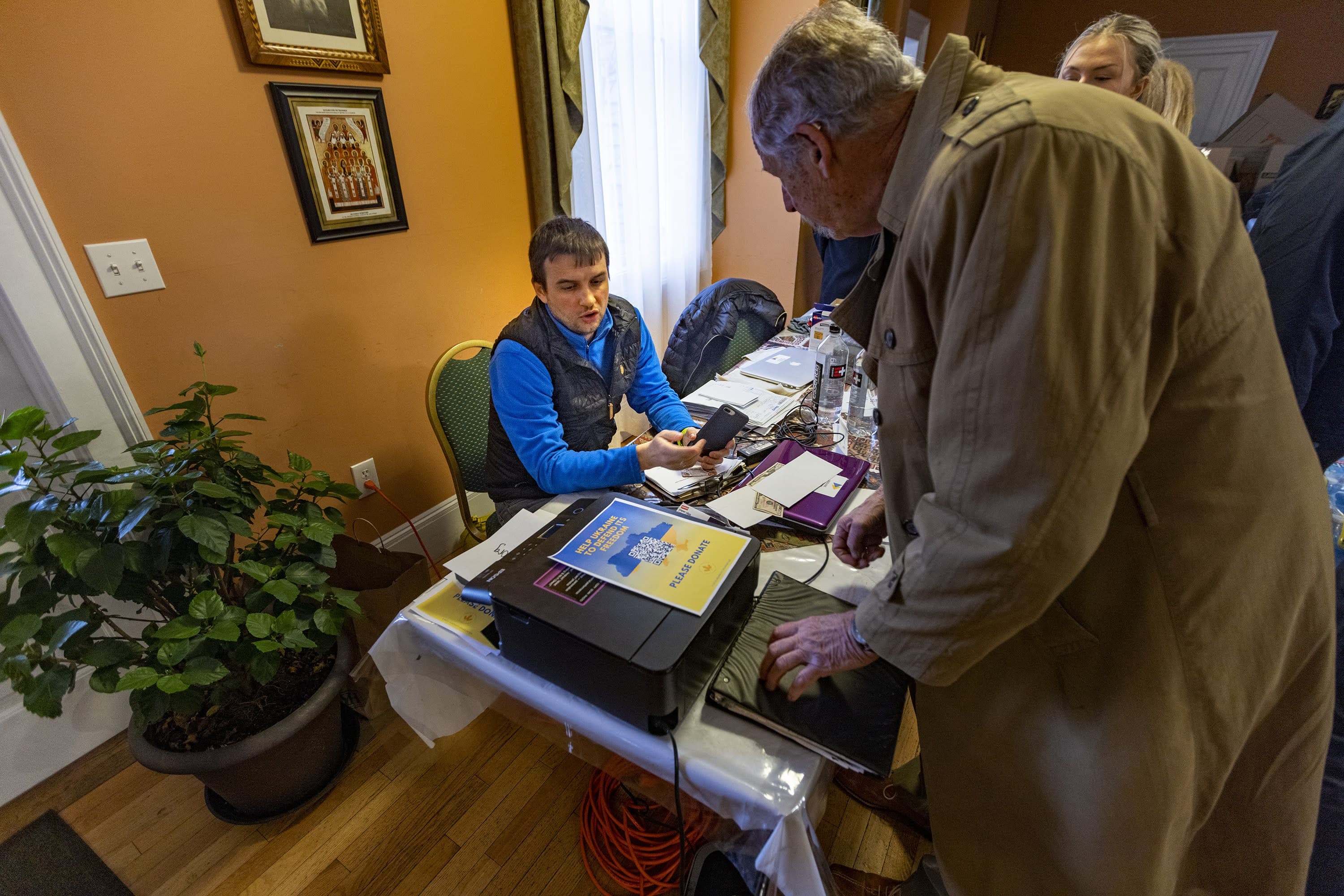 Myron Kravchuk accepts donations to aid the people of Ukraine at the Christ the King Ukrainian Catholic Church in Jamaica Plain. (Jesse Costa/WBUR)